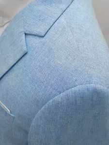 Detailed close up view of light blue linen cotton blend suit jacket shoulder texture.