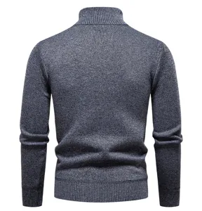 Men's winter thick knit turtleneck sweater, back view detail showing ribbed hem and long sleeves.