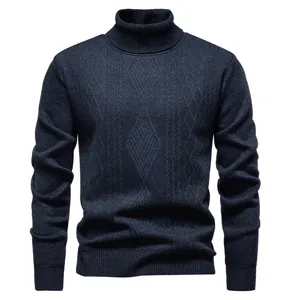 Close-up details of dark blue cable knit turtleneck sweater showing unique diamond pattern texture.