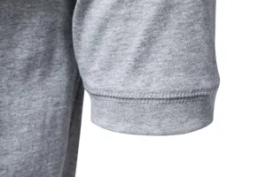 Close-up detail of gray cotton mens t-shirt sleeve cuff, fine stitching craftsmanship.