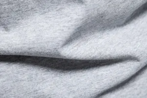 Grey cotton t-shirt fabric texture close up, soft knit material detail for men casual wear.