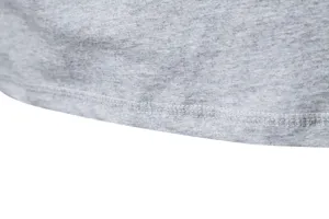 Close-up of grey cotton t-shirt hem with fine stitching texture and durable double-needle finish.