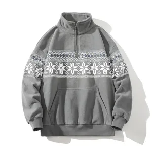 Close-up detail of the grey fleece half-zip sweatshirt featuring winter snowflake print.