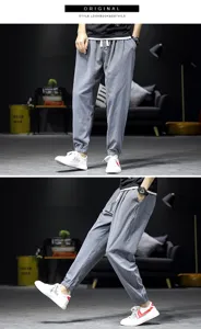 Detailed view of men casual linen joggers, loose cuffed harem pants in stylish grey tone.
