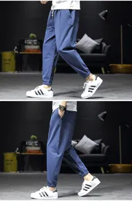 Detail view of men casual linen jogger pants showing loose fit and cuffed ankle design.
