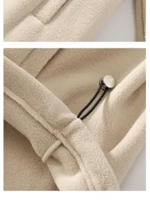 Close-up detail of mens beige fleece hoodie, showing soft fabric texture and metal cord stopper.