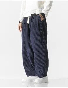 Detailed shot of men's dark blue corduroy wide leg harem casual pants with soft texture.