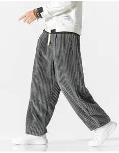 Detail view of men's corduroy wide leg trousers, casual harajuku style pants with drawstring.