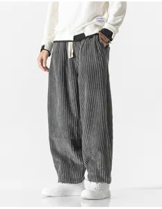 Corduroy casual trousers detail view, wide-leg harem pants style in dark grey, comfortable fit.