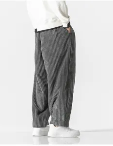 Close-up detail of men's gray corduroy loose harem pants, showing fabric texture and fit.