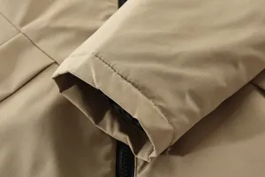 Men's winter jacket detail close-up, khaki fabric sleeve cuff and zipper display.