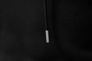 Men's casual hoodie detail shot showcasing the black fabric texture and metal-tipped drawstring.