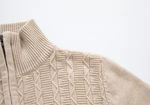 Close-up detail of mens half-zip stand collar knit sweater in khaki, textured cable knit fabric.