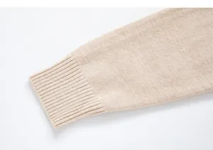 Close-up of the ribbed cuff and knit sleeve detail on a casual men's beige pullover sweater.