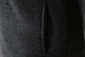 Close-up detail view of men's casual hooded sweatshirt jacket, dark gray soft fabric.