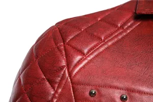 Primer plano detalle hombro chaqueta de moto de cuero sintético acolchado rojo con tachuelas.