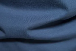 Close-up fabric detail of soft blue cotton knit textile material texture view
