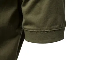 Close-up detail shot of mens solid green short sleeve t-shirt cuff showing fine fabric texture.