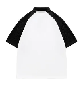 Detail view of the black and white color block polo shirt, casual summer short sleeve top.