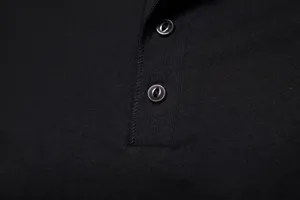 Close-up detail of men's solid black short sleeve polo shirt collar and button placket texture.