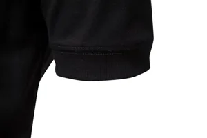 Close-up detail of the black short sleeve cuff, showing fine stitching and ribbed knit fabric texture.