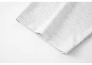 Grey knitted fabric detail close up showing soft cotton texture and clean surface