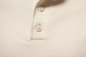 Men's casual solid color polo shirt detail shot, soft cotton fabric with button placket.