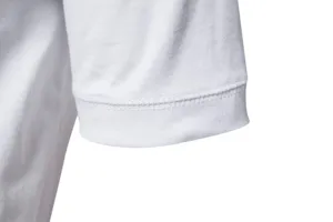 Close-up view of a men's white cotton short sleeve cuff, showing fine stitching and quality workmanship.