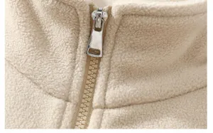 Close up detail view of mens casual fleece jacket high collar and metal zipper, soft texture.