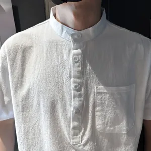 Close-up detail of mens white cotton linen short sleeve shirt, mandarin collar and buttons.