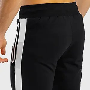 Men's black casual sweatpants featuring striking white side stripes and a convenient zipper pocket detail.