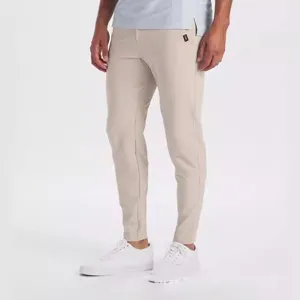 Close-up detail of men's slim-fit casual trousers in khaki with elastic stretch fabric.