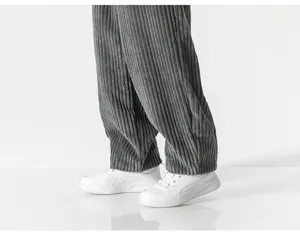 Close-up detail shot of men's casual corduroy trousers paired with stylish white sneakers.