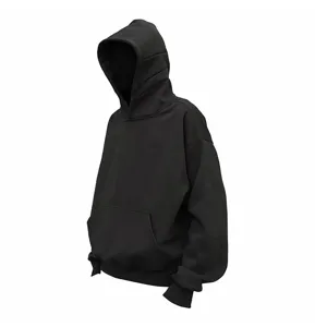 Close-up detail of the black oversized hoodie showing the spacious hood and cozy pocket.