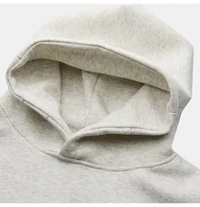 Close-up detail of casual heather grey hoodie hood and neckline with soft fabric texture.
