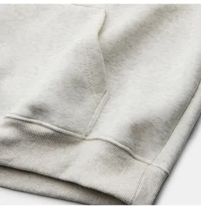 Close up detail of mens casual grey heather hoodie pocket and ribbed hem texture.