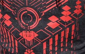 Close-up detail of dark grey long-sleeve apparel with bold red geometric print and drawstring.