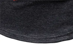 Close-up detail of stretchy dark grey fabric, showing fine stitching and durable garment quality.