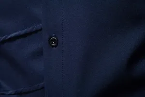 Men's navy blue dress shirt fabric detail view showing front button and fine stitching texture.