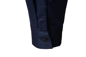 Close-up detail of a men's dark blue long sleeve shirt cuff with a button, premium texture.
