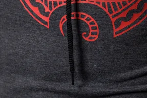 Detailed view of men's athletic long sleeve hoodie with red tribal graphic print.