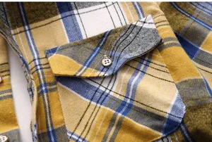 Men's plaid short sleeve shirt detail view showcasing chest pocket and fabric texture.
