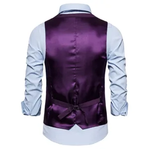 Men's purple suit vest paired with a light blue long sleeve dress shirt. Ideal for business.