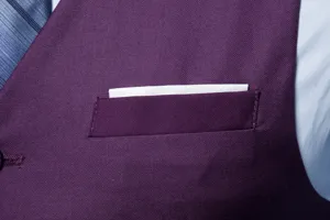 Close-up view of men's purple suit vest fabric texture and pocket design detail.
