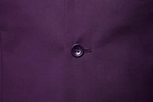 Purple suit vest fabric detail closeup with matching button for men's formal wear.