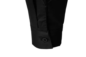 Detailed view of men's black long sleeve shirt cuff with pleated design and button accent.