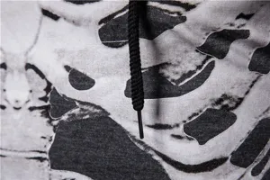 Close-up detail of mens skull print hoodie fabric texture and black drawstring design.