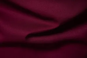 Burgundy pleated men shirt fabric detail closeup, soft material, elegant drape, fashion style.