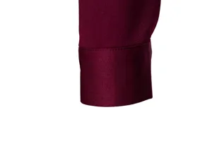 Close-up detail showing the refined cuff craftsmanship of a classic men's burgundy shirt.