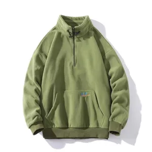 Men's half-zip fleece sweatshirt detail showing soft texture, high collar and pocket.